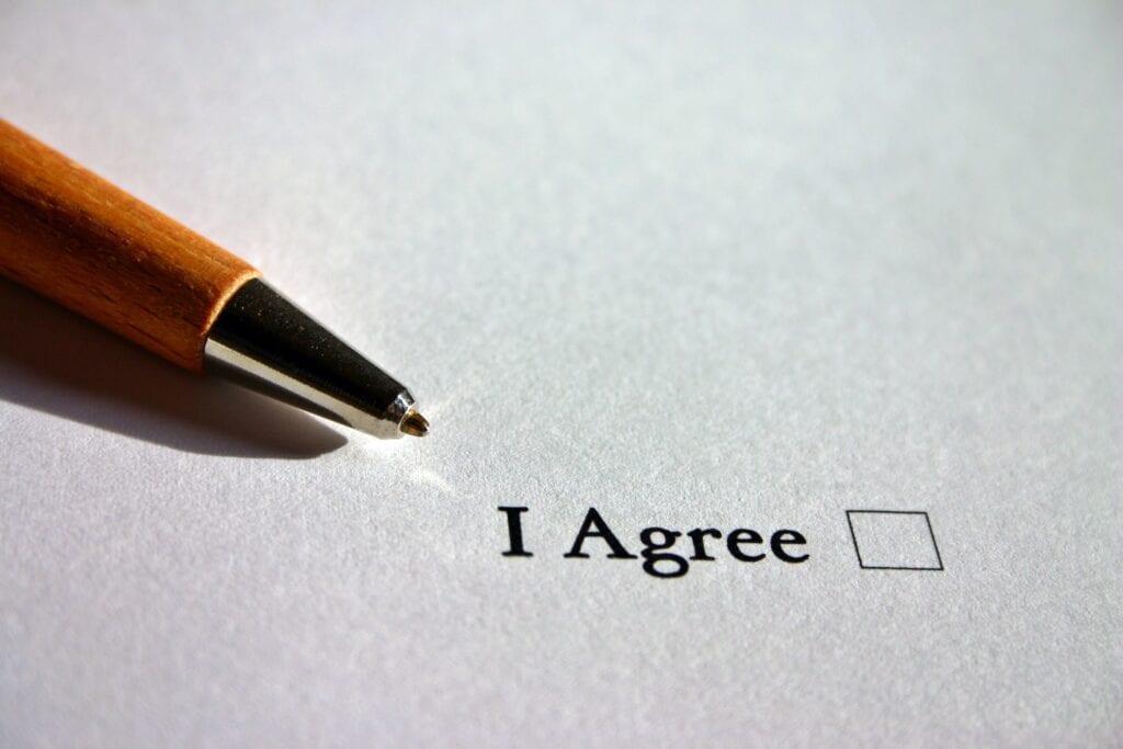 Pen beside I Agree checkbox on paper