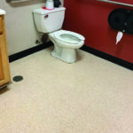 Accessible public restroom with toilet and grab bar